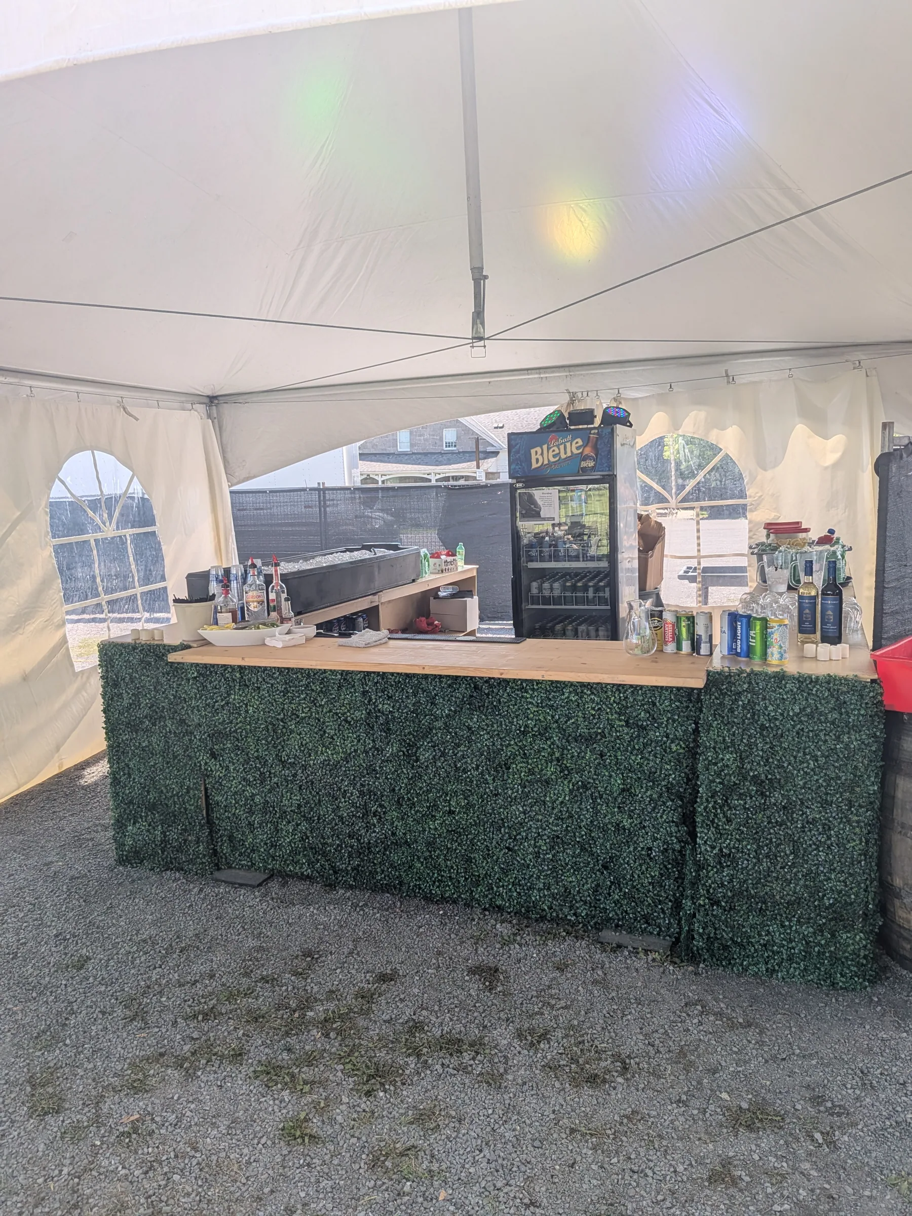 Greenery-clad bar under a marquee, DevFest